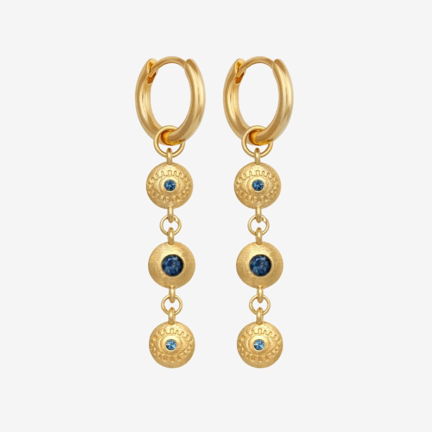 The Temple Of The Sun Blessing Earrings in Gold on a grey background