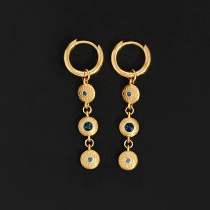 The Temple Of The Sun Blessing Earrings in Gold on a black background