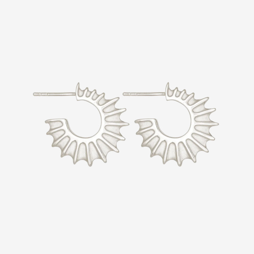 The Temple Of The Sun Calypso Hoops in Sterling Silver on a grey background