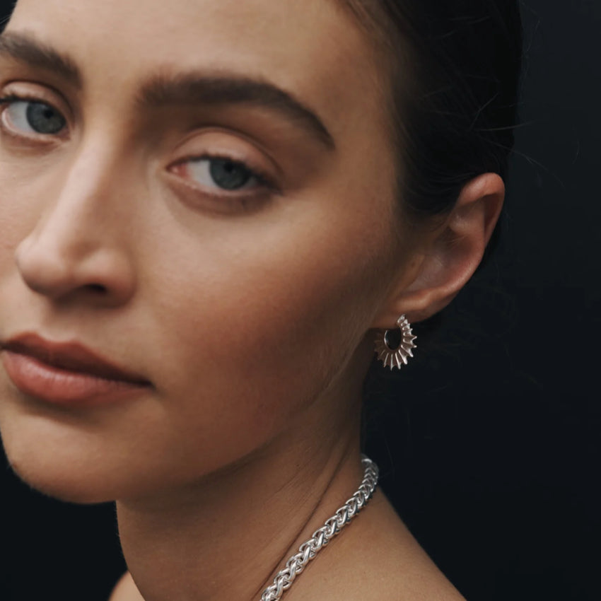 The Temple Of The Sun Calypso Hoops in Sterling Silver on a model 