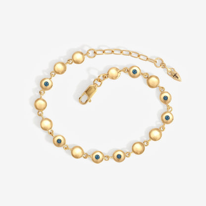 The Temple Of The Sun Mavi Chain Bracelet in Gold on a grey background