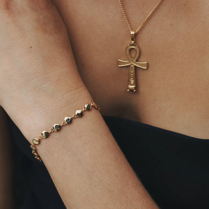 The Temple Of The Sun Mavi Chain Bracelet in Gold on a model's wrist