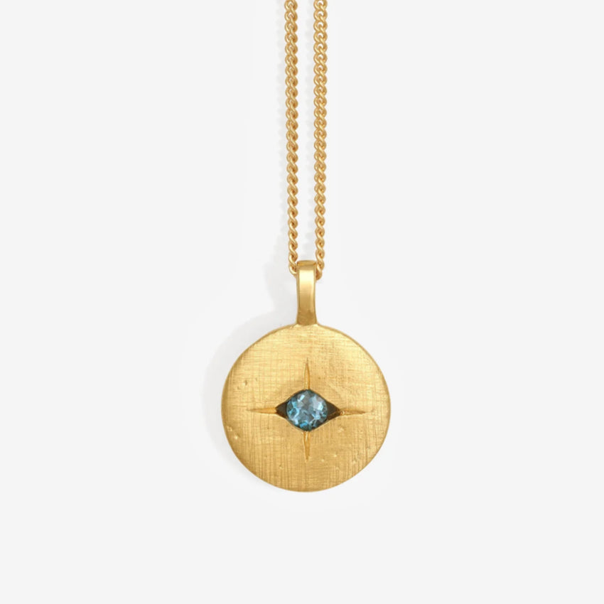 The Temple Of The Sun Mavi Eye Necklace in Gold on a grey background