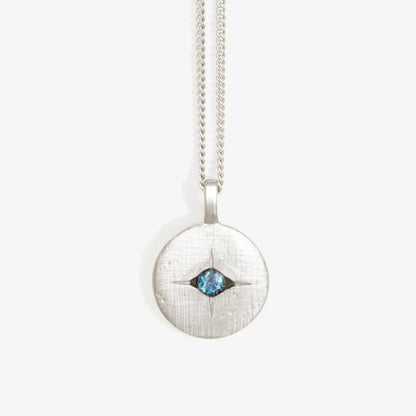 The Temple Of The Sun Mavi Eye Necklace in Sterling Silver on a grey background