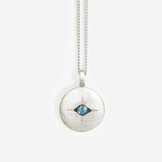 The Temple Of The Sun Mavi Eye Necklace in Sterling Silver on a grey background
