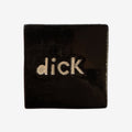 The Monster Company black square tile with ' dick' text on a grey background