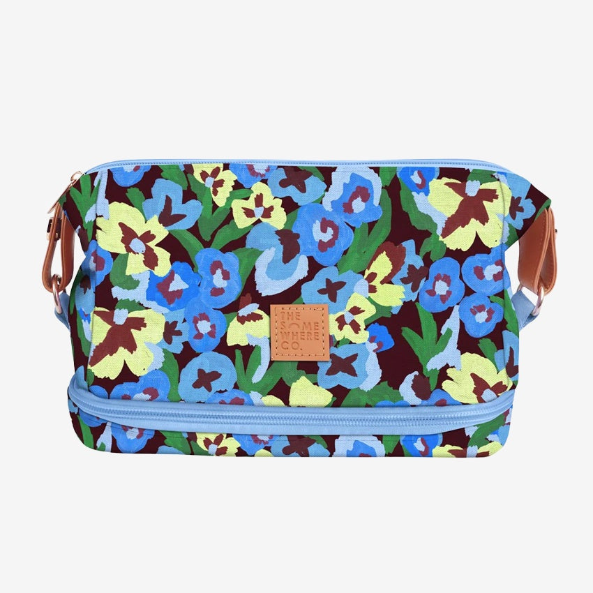 The Somewhere Co Cosmetic Bag in Pansy Path on a grey background