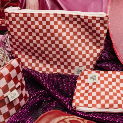 The Somewhere Co Handy Pouches in Crimson Haze in a styled shot