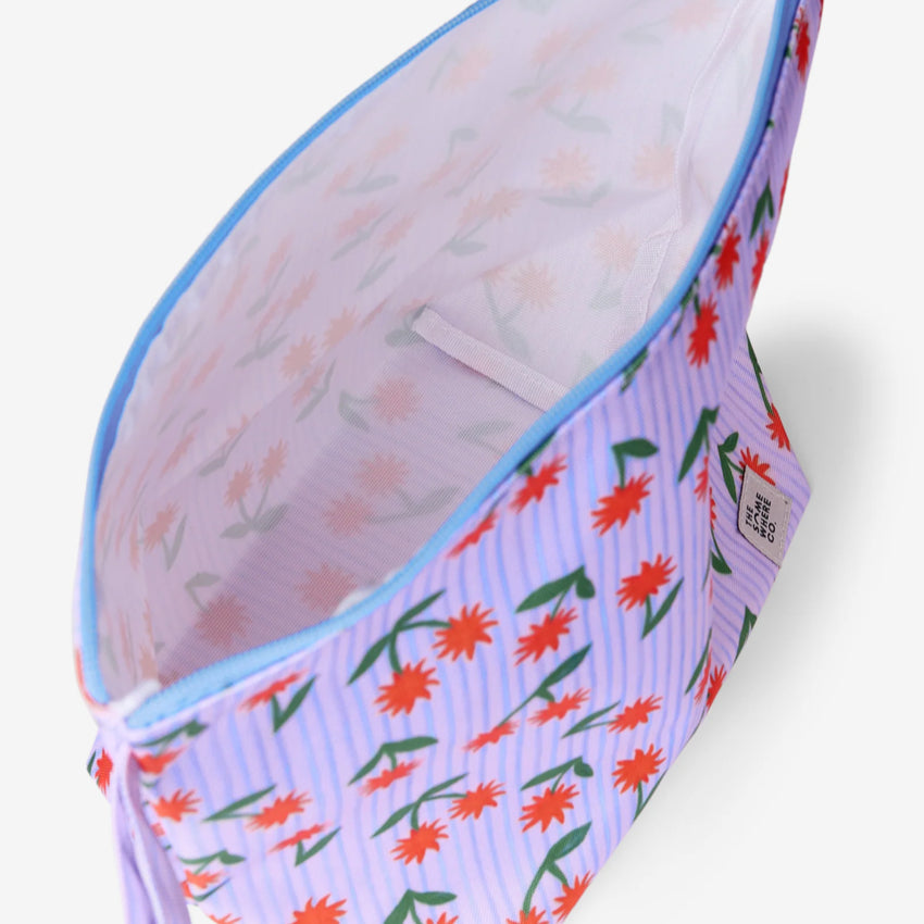 An inside view of The Somewhere Co Handy Pouches in Sunburst on a grey background