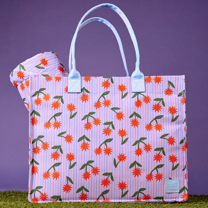 The Somewhere Co Ultimate Tote in Sunburst on grass