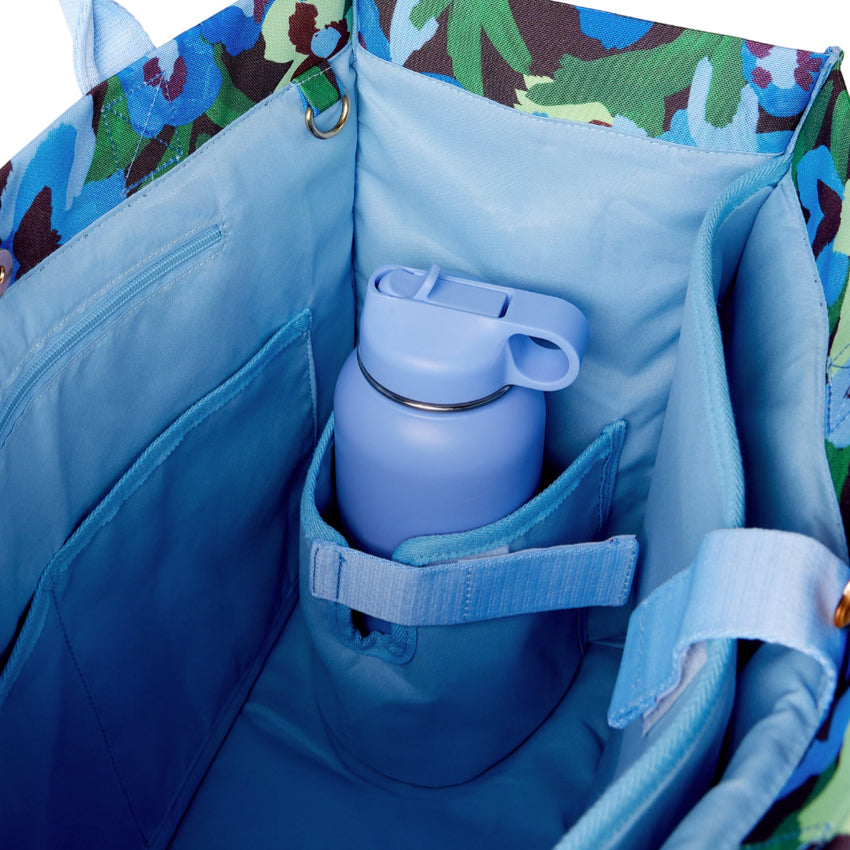 An inside view of The Somewhere Co Ultimate Tote in Pansy Patch with a bottle in it