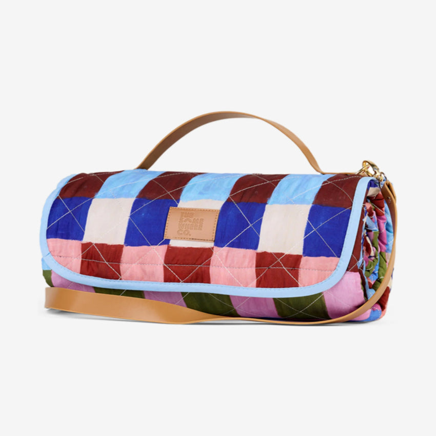 The Somewhere Co XL Picnic Rug in Hopscotch on a grey background