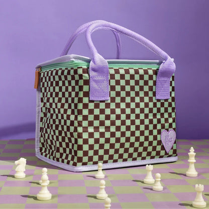 The Somewhere Co Lunch Bag in Lover's Muse on a chess board and purple backdrop