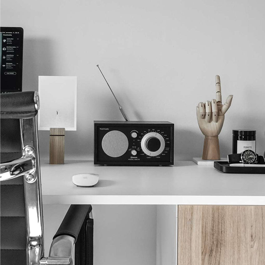 The Tivoli Audio Model One BT in Black and Black on a desk 