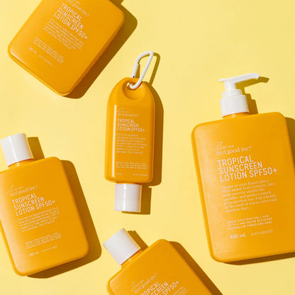 The We Are Feel Good Inc Tropical Sunscreen in 200ml, 400ml and 75ml on a yellow background