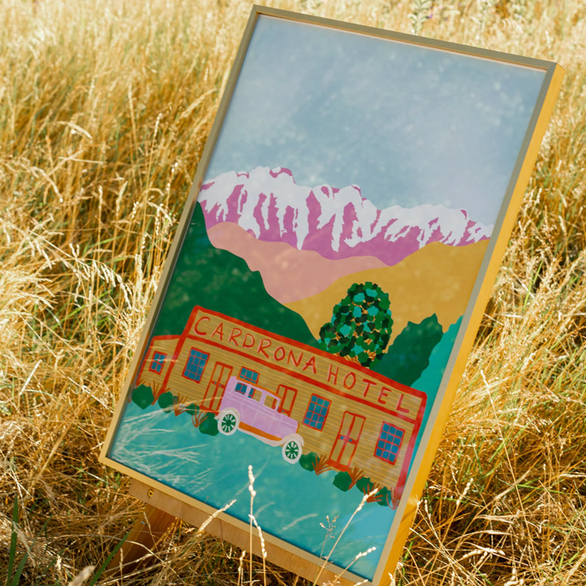 The West Moor Design Cardrona Art Print in a frame on an easel in long grass