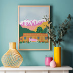 The West Moor Design Cardrona Art Print in a wooden frame hanging on a wall above vases
