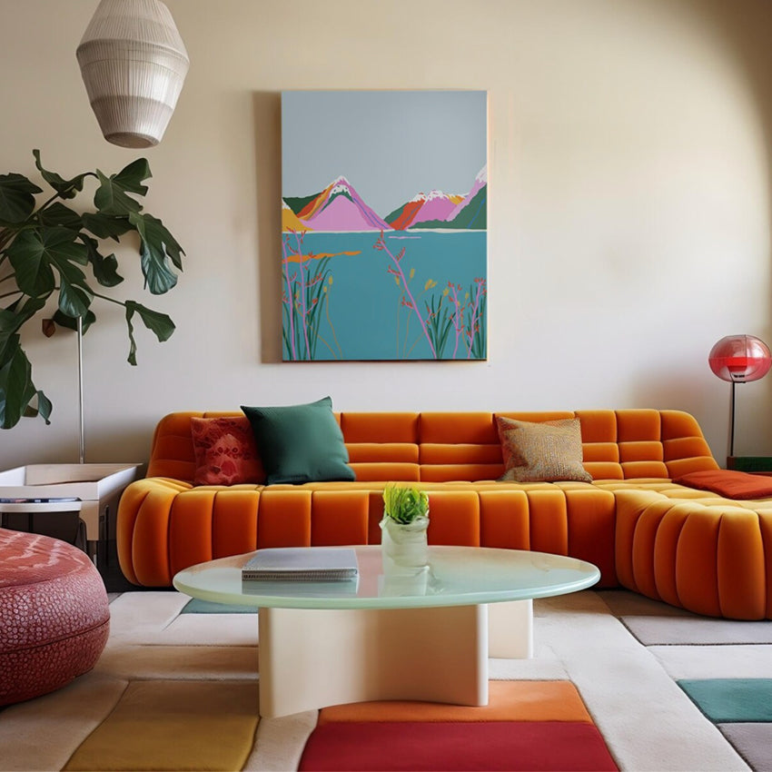 The West Moor Design Milford Sound Art Print hanging on a wall above an orange couch