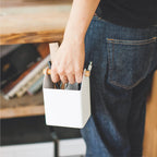 A person holding the Yamazaki Tosca Organiser in Small with stationery in it