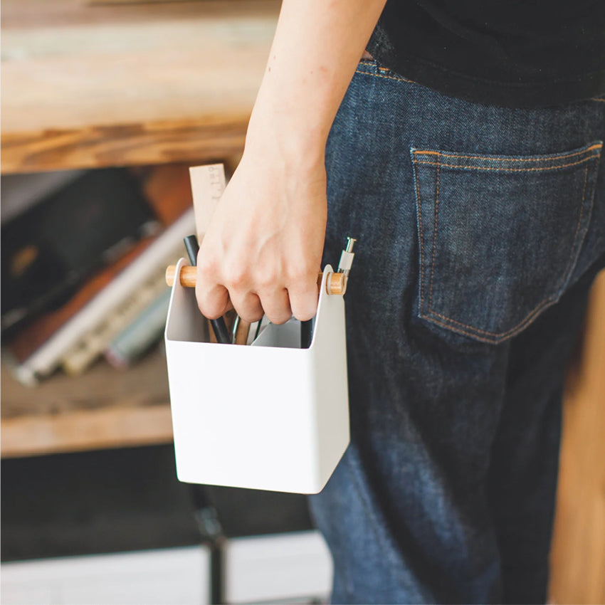 A person holding the Yamazaki Tosca Organiser in Small with stationery in it