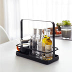 The Yamazaki Tower Seasoning Rack in Black on a kitchen bench with oils and salt and pepper in it