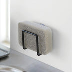The Yamazaki Tower Sponge Holder in Black with a sponge in it