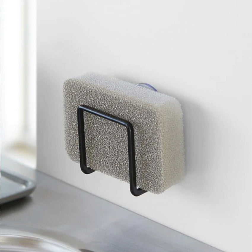 The Yamazaki Tower Sponge Holder in Black with a sponge in it