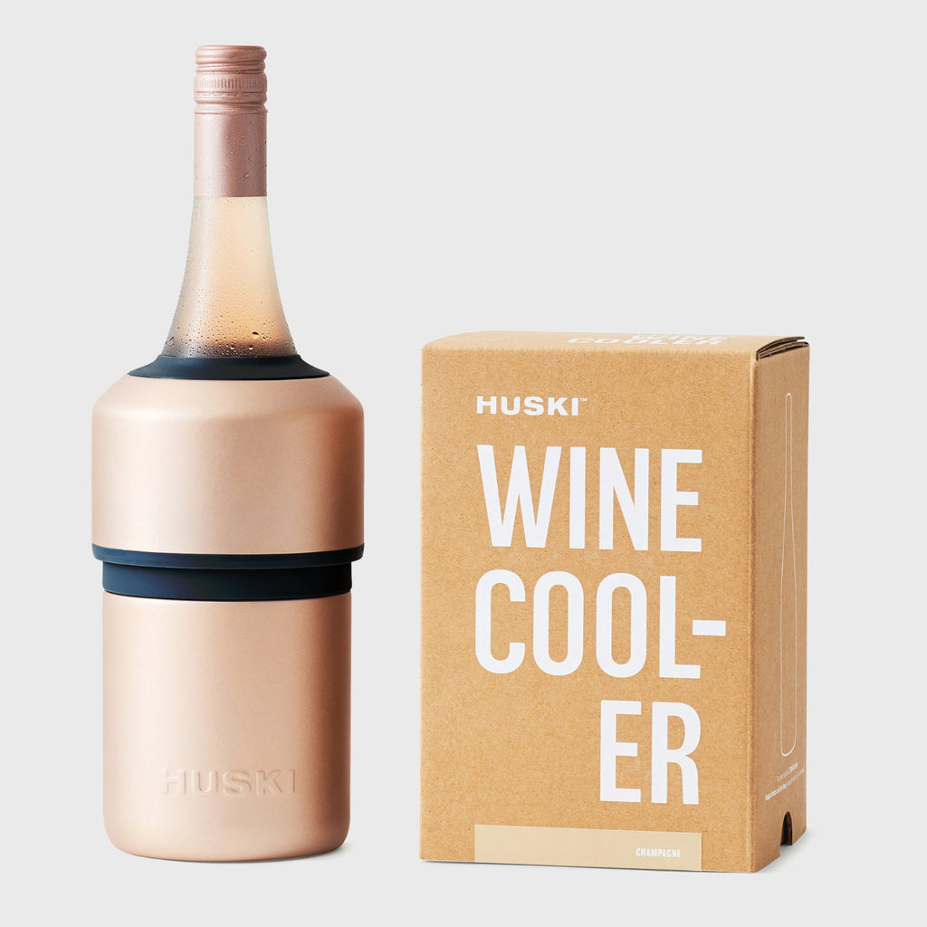 The Huski Wine Cooler in Champagne with a wine bottle in it and next to its box on a blank background