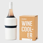 The Huski Wine Cooler in White with a wine bottle in it and next to its box on a blank background
