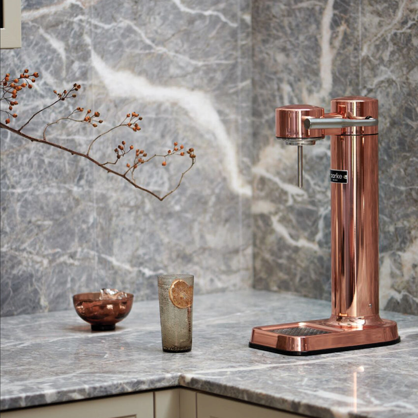 The Aarke Carbonator 3 in Copper on a  kitchen bench