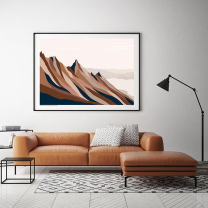 The Bridget Hall Isthmus Peak Trail Art Print in a black frame hanging above a couch