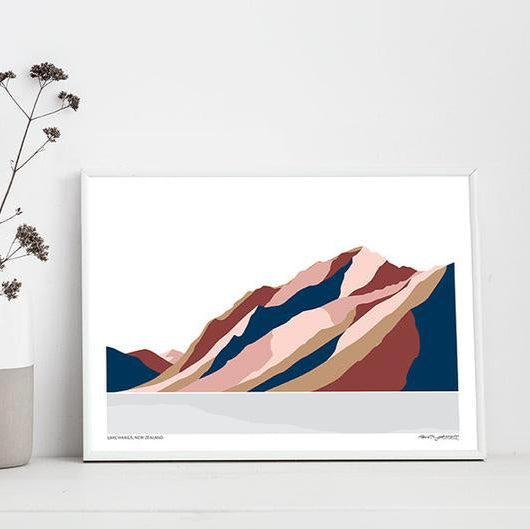A modern art print of Lake Hawea and Corner Peak in shades of blue and pink by Bridget Hall in a frame