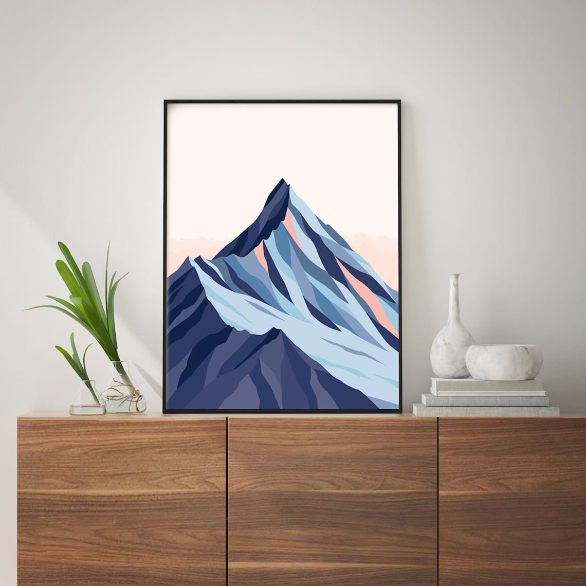 The Bridget Hall Mt Aspiring art print in a black frame on a console 