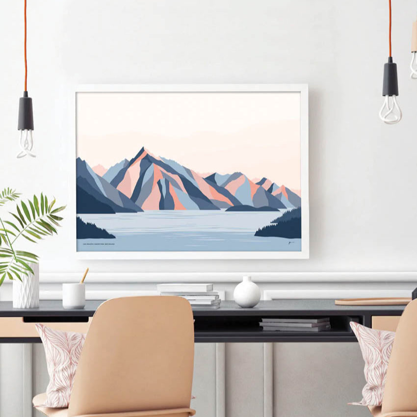 The Bridget Hall Designs Queenstown Mountains Art Print hanging on a wall infront of a desk