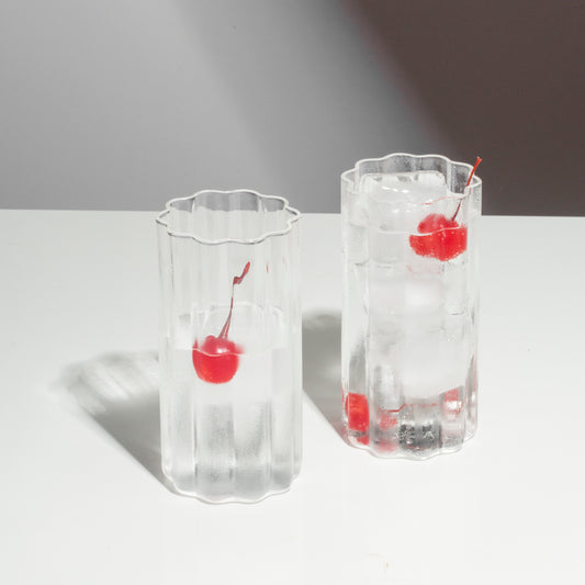 Fazeek Wave Highball Glasses in Clear with drink and cherries in them
