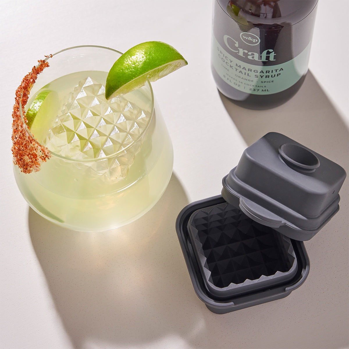 The Peak Cubic Cocktail Ice Cube with the ice cube in a cocktail