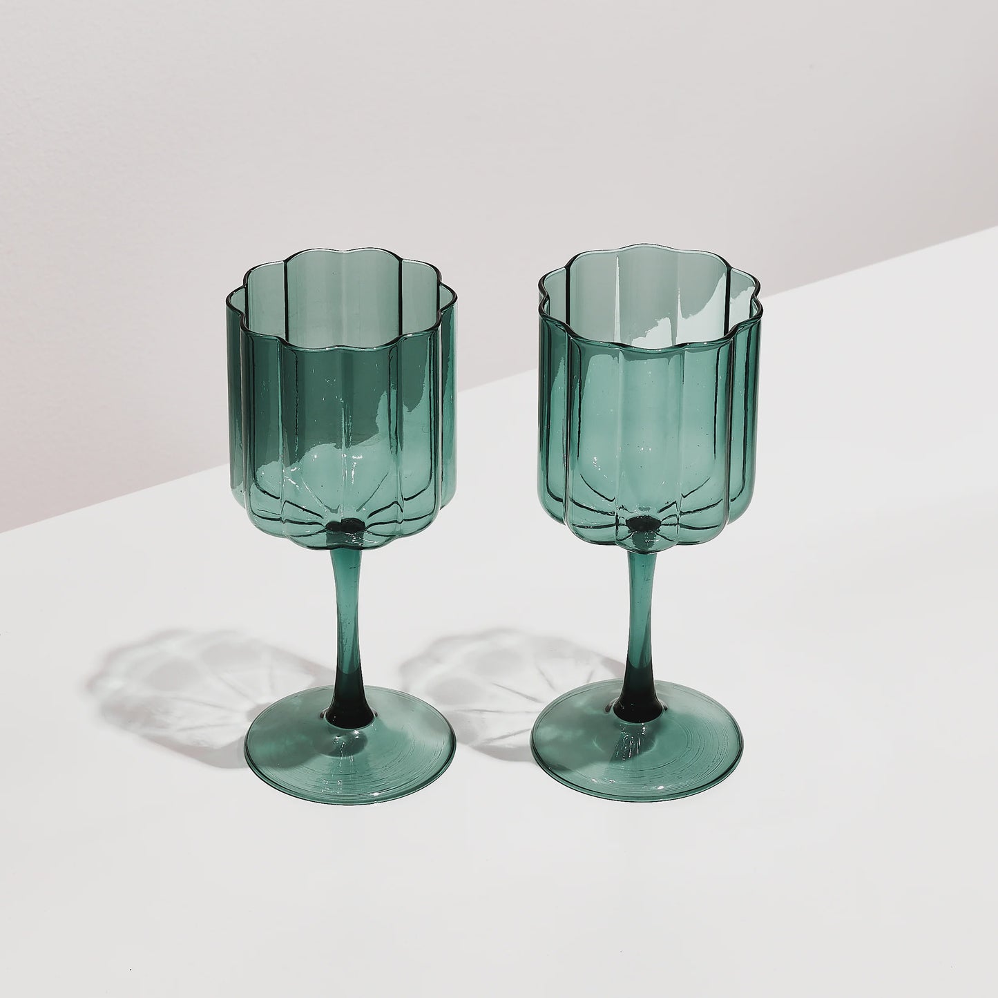 The Fazeek Wave Wine Glasses in Teal on a blank background