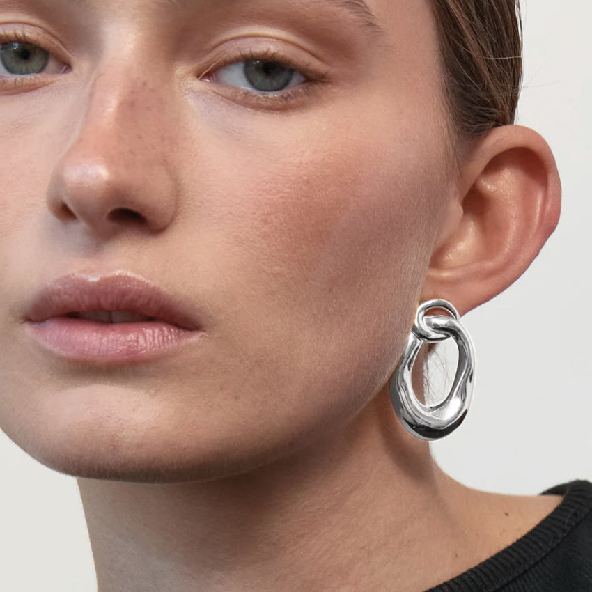 The Nina Gordon Voyage Door Knocker Earrings in Silver on a model