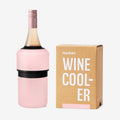 The Huski Wine Cooler in Powder Pink with a wine bottle in it and next to its box on a blank background