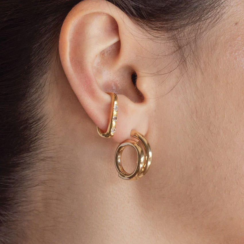 The Nina Gordon Venus Hoops Small in Gold on a model