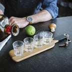 Gentlemen's Hardware Serving Paddle in action with tequila being poured into the shots glasses and lime and salt on the side
