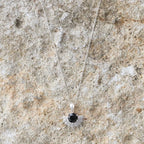 The Silver Linings Collective Solace Necklace in Silver on a textured background