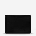 The Status Anxiety Jonah Wallet in Black on a blank background