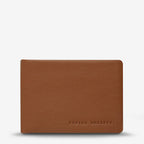 The Status Anxiety Jonah Wallet in Tan on a blank background