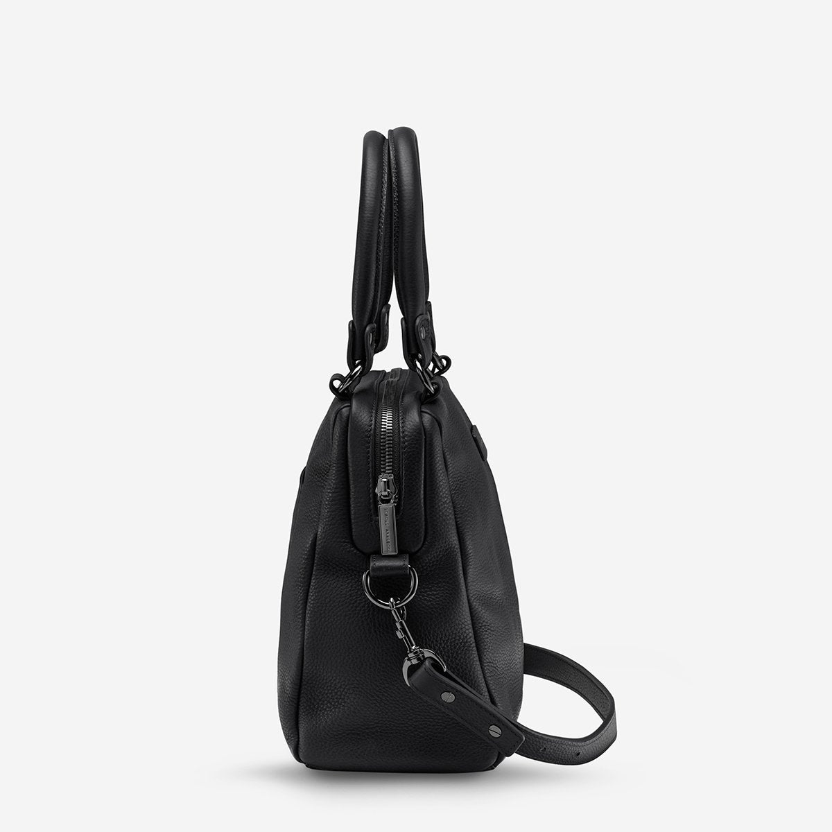 A side view of the Status Anxiety Last Mountains Bag in Black on a blank background