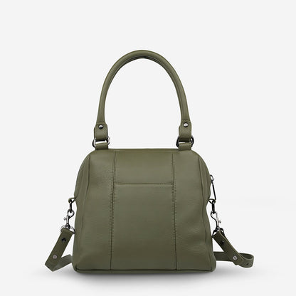 The back of the Status Anxiety Last Mountains Bag in Khaki on a model