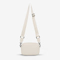 The Status Anxiety Plunder Bag with Webbed Strap in Chalk on a blank background
