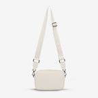 The Status Anxiety Plunder Bag with Webbed Strap in Chalk on a blank background