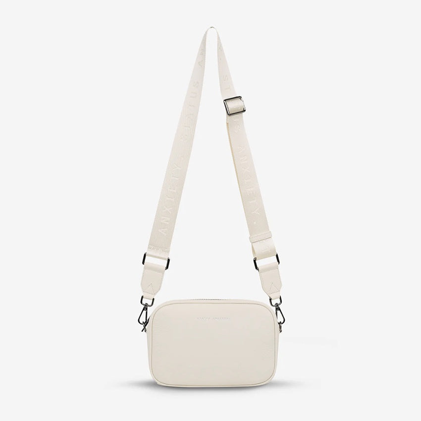 The Status Anxiety Plunder Bag with Webbed Strap in Chalk on a blank background