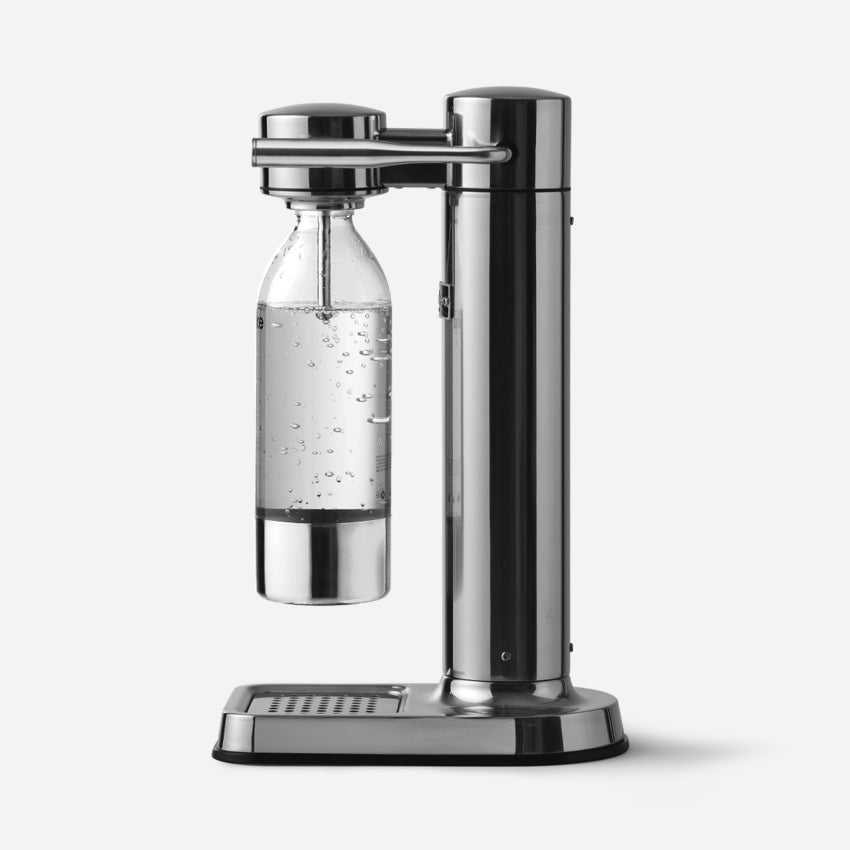 The Aarke Carbonator 3 in Steel with a PET Water Bottle in it on a blank background